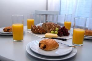 a table with plates of food and glasses of orange juice at Alston House in Hartlepool