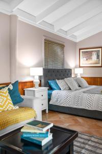 a living room with two beds and a coffee table at Brisbane River Cabin in Mount Ommaney