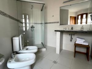 a bathroom with a shower and a toilet and a sink at HOSPEDAJE SARABIA in Sucre