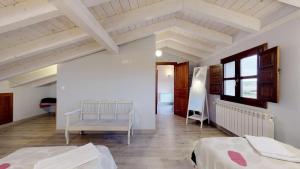 a large room with two beds and a window at Casa rural El Veredero in Castrojeriz
