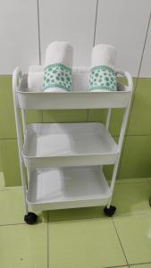 a towel rack with white shelves and towels at Rock & Roll 1 - Modern apartment in Trikala in Tríkala