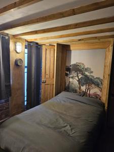 a bedroom with a bed and a clock on a wall at Shoreditch Heights- Central ground floor apartment in Exeter