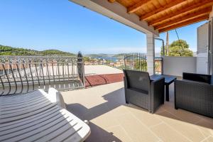 a balcony with a bench and a table and chairs at House Neda in Ražanj