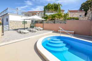 a swimming pool in front of a house at House Neda in Ražanj