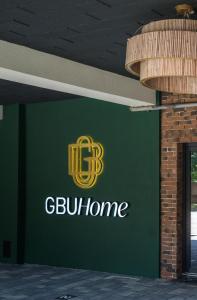 a green wall with theogl home logo on it at GBU Home Timisoara in Timişoara