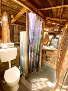 a bathroom with a toilet and a sink at Magical Treehouse in Lagos