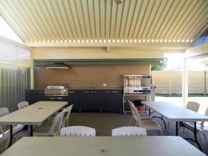a cafeteria with tables, chairs, and tables in it at cluBarham Motel in Barham