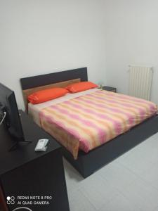 Schlafzimmer mit einem Bett und einem Tisch mit einem TV in der Unterkunft House San cataldo in San Cataldo