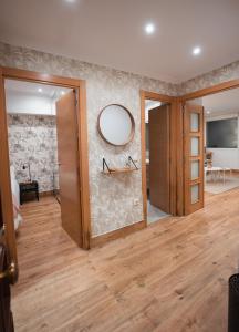 a room with a mirror on the wall and a room with a table at La Concha Pearl Beach Apartment in Donostia-San Sebastián