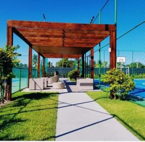 a pavilion with a basketball court and a pool at Flat Palm village in Porto De Galinhas