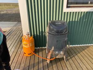 Ein Hund mit einem orangenen Schlauch, der an einen Hydranten angeschlossen ist. in der Unterkunft Áfangi in Blönduós