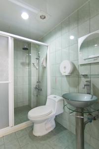 a bathroom with a toilet and a sink at HC Inn in Hengchun