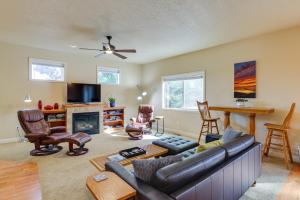 a living room with a couch and a fireplace at Bend Getaway with Private Hot Tub, Patio and Grill! in Bend