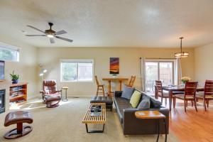 a living room with a couch and a table at Bend Getaway with Private Hot Tub, Patio and Grill! in Bend