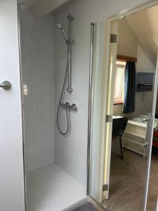 a shower with a glass door in a bathroom at Les Marmottes in Éghezée +16 photos