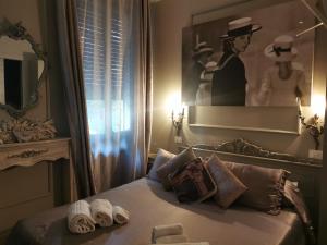a bedroom with a bed with two towels on it at L'Antico Lido Venice in Venice-Lido