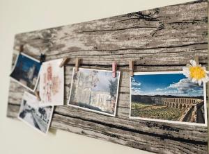 a group of pictures hanging on a wooden wall at Casa da Levada in Tomar