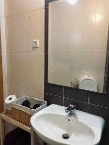 a bathroom with a sink and a mirror and a toilet at Casa da Levada in Tomar