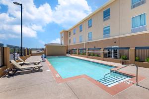 a swimming pool in front of a building at Quality Inn & Suites Carlsbad Caverns Area in Carlsbad