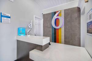 a lobby with a colorful sign on the wall at Studio 6 Eureka CA Old Town in Eureka