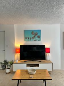a living room with a tv and a coffee table at Meridian Tower Kirra Beach in Gold Coast