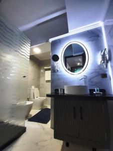 a bathroom with a sink and a mirror at Balcon Bleu in Chefchaouene