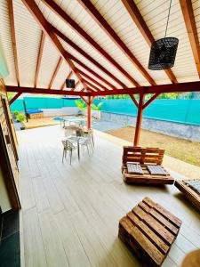a pavilion with benches and a table and a patio at Villa senseo in Capesterre-Belle-Eau