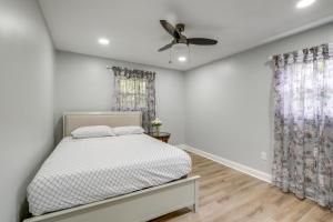 a bedroom with a bed and a ceiling fan at Fort Washington Home Close to National Harbor in Fort Washington