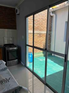 a room with a view of a swimming pool through a window at Relax 6 in Paysandú