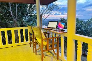 - une table avec 2 ordinateurs portables au-dessus du balcon dans l'établissement Breathtaking Sea View house from your BED - 3 min to BEACH, à Koh Samui 