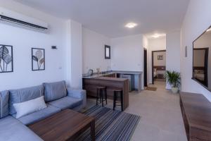 a living room with a couch and a kitchen at Sola inn in Hurghada