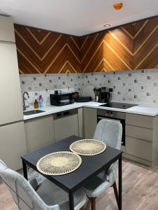 a kitchen with a table and chairs in a kitchen at 2 bedrooms apartment in 5 stars Hotel comfort in Istanbul
