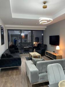 a living room with couches and a tv at 2 bedrooms apartment in 5 stars Hotel comfort in Istanbul