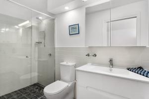 a bathroom with a toilet and a sink and a shower at Hobart studio - Courtyard on Argyle in New Town