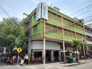 a green and white building with a sign on it at Hotel Sion Real in Neiva