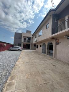 un coche aparcado frente a un edificio en Akua’s Cottage, en Accra