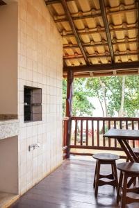 a patio with a table and two chairs and a balcony at Concha Tropical Flat in Itacaré