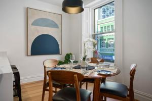 a dining room with a table and chairs and a window at Saddlers House - Vintage Suite - Cafe Lifestyle in Hobart
