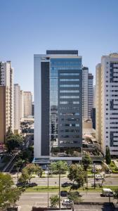 a large tall building in a city with tall buildings at Helbor Stay Batel in Curitiba