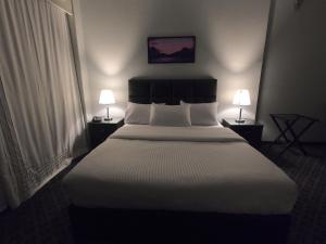 a large bed in a hotel room with two lamps at Borg El Thaghr Hotel in Alexandria