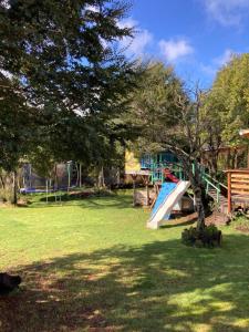 a playground with a slide in a park at El Viloche - Tiny House in Puerto Montt