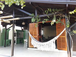 a hammock hanging from the outside of a house at Chalé da Val in Palhoça +16 photos