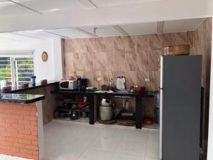 a kitchen with a counter and a refrigerator at Lago calima cabaña in Darién