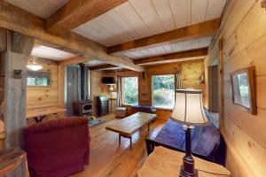 a living room with a couch and a table in a cabin at The Canopy House in Clinton