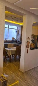 Résidence nahda في أغادير: مطبخ وغرفة طعام مع طاولة وكراسي