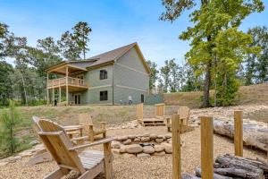 a house with chairs and a fire pit in front of it at Firefly Meadows in Ellijay