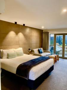 una camera d'albergo con due letti e un divano di Arrowtown Motel ad Arrowtown