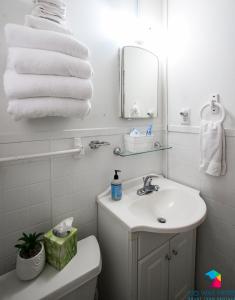 a bathroom with a sink and a toilet and towels at Affordable, Walkable Near Forsyth Park Free Parking in Savannah