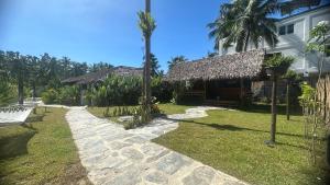 a pathway leading to a house with a resort at Yumi Villas in San Vicente