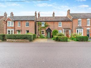 a row of red brick houses with a driveway at Old Orchard Cottage in Dilton